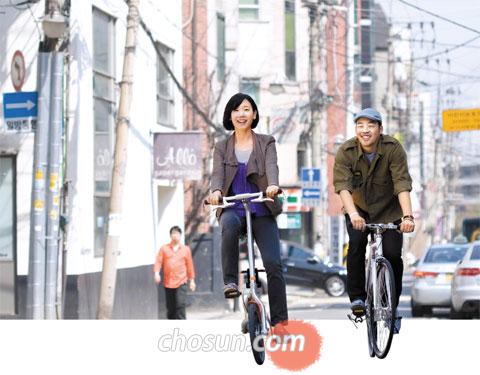 임동준, 김혜원 부부가 자전거를 타고장을 보러 가고 있다. 혜원씨는“자전거를 타면 우리 몸도 건강해지고 지구도 건강해지는 데다 돈도 안 들어서 정말 좋지 않을까요”라며 웃었다. /이경섭 객원기자