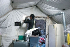 비닐하우스에 사는 독거 어르신을 위해 전기배선 시공하는 봉사자의 모습 /도촌종합사회복지관 제공