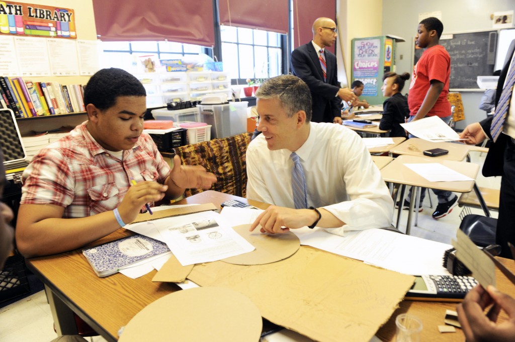 U.S. Secretary of Education Arne Duncan works with Josian Estrella, tenth grader, in an Algebra class at P-TECH (Pathways in Technology Early College High School), a grades 9-14 school that combines high school and college with career and technical education, Tuesday, October 23, 2012 in Brooklyn, NY.  The school is a collaboration with the New York City Department of Education, the City University of New York and IBM and is designed to prepare students to fill entry-level jobs in technology fields. (Feature Photo Service)
