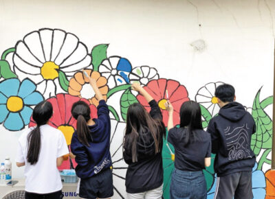 국제학교 NLCS제주의 봉사동아리 ‘펭귄빌리지’ 학생들이 지역 특색을 살린 벽화 그리기 봉사를 하고 있다. /KB라이프생명사회공헌재단